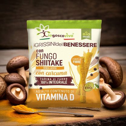 Confezione dei Grissini alla Curcuma e Shiitake BIO 50 g con funghi shiitake e un cucchiaio di curcuma.