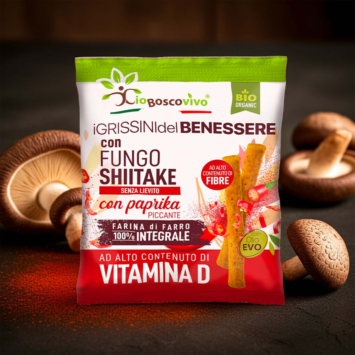 Confezione dei Grissini alla Paprika Piccante e Shiitake BIO 50 g circondata da funghi shiitake.